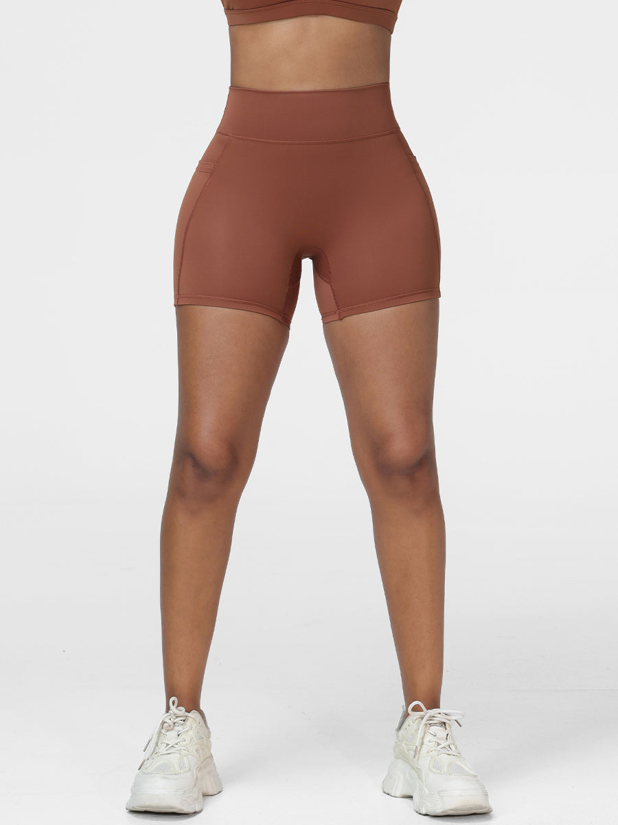 Workout shorts with pockets in Brown - front view showing the high rise waistband.
