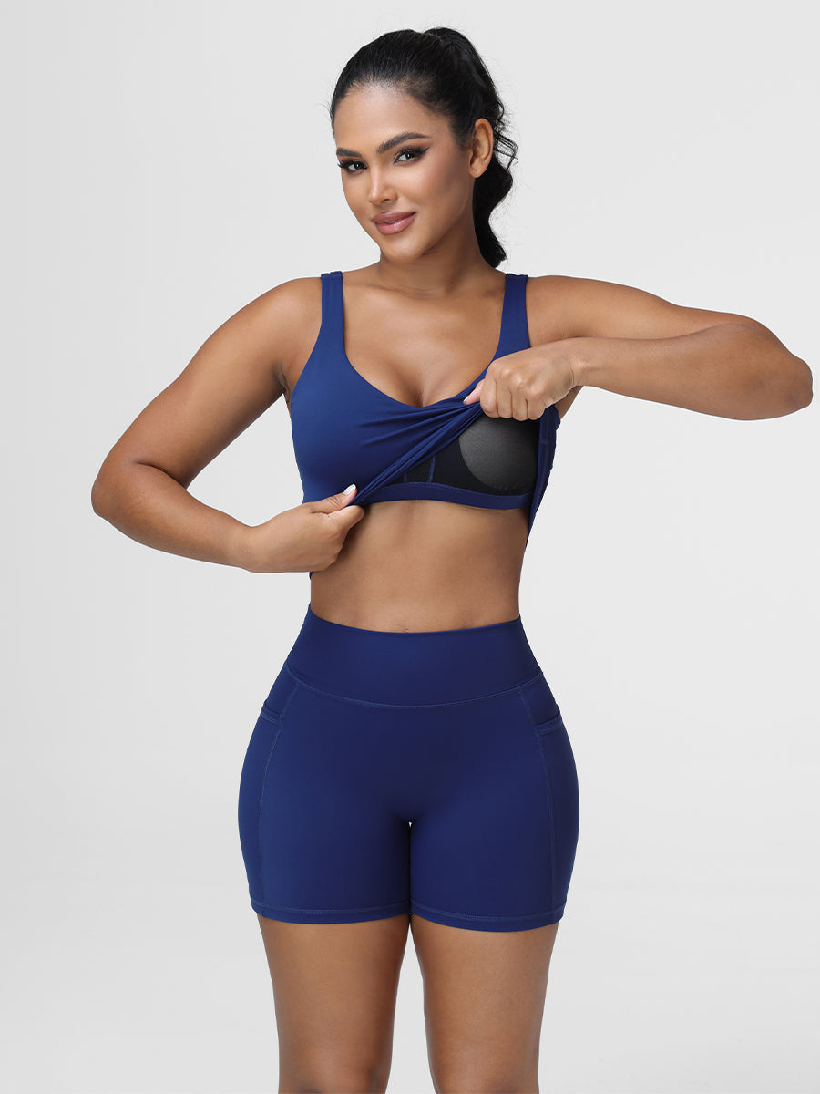 Close-up of the longline sports bra in Navy Blue showing the scoop neckline and removable pads.