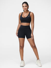 Adjustable strap sports bra and high rise shorts set in Black - front view, two-piece set.