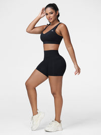 Adjustable strap sports bra and high rise shorts set in Black - side view of the light support bra.