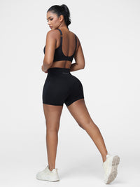 Adjustable strap sports bra and high rise shorts set in Black - three quarter back view of the set.