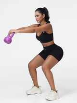 Adjustable strap sports bra and high rise shorts set in Black - side view showing the seamless shorts.
