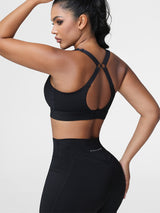Adjustable strap sports bra in Black - back view showing the cut-out racerback strap design.