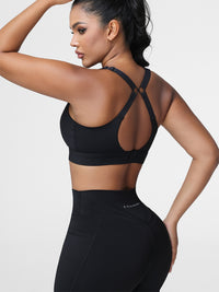 Adjustable strap sports bra in Black - back view showing the cut-out racerback strap design.