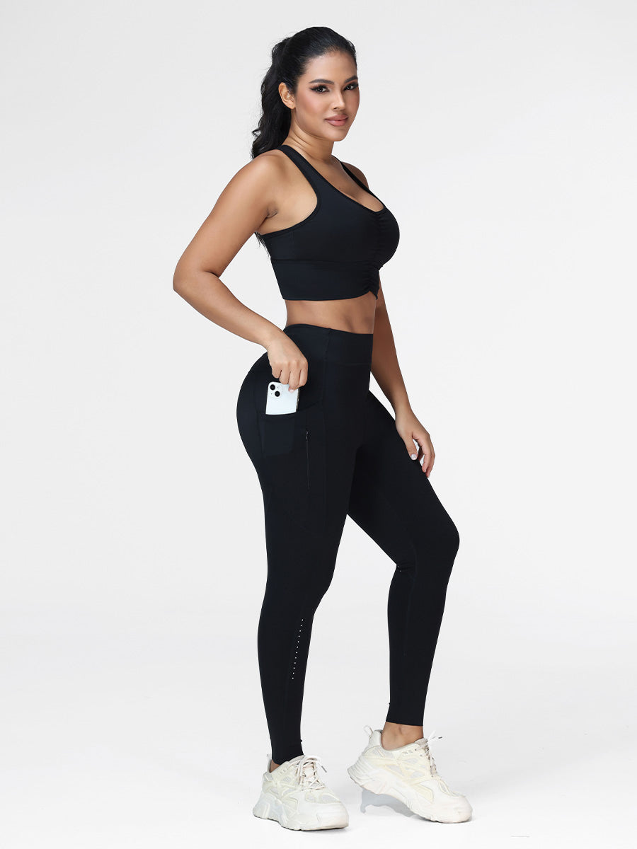 Women's running set in Black - three quarter view showing the zipped side pocket and the phone holder.