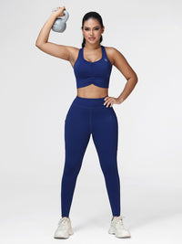 Women's running set in Navy Blue - front view showing the ruched sports bra and high waist pocket leggings, two-piece set.