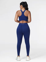 Running set for women in Navy Blue - back view showing the racerback sports bra and the wide waistband leggings.