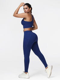 Running set for women in Navy Blue - side view showing the racerback bra and the slim fit pocket leggings.