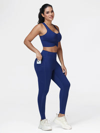 Women's running set in Navy Blue - three quarter view showing the ruched bra and the zipped pocket leggings.