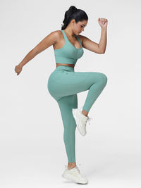 Women's running set in Green - side view showing the contoured fit of the pocket leggings.