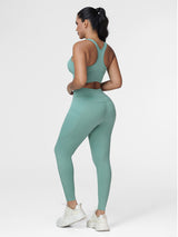 Running set for women in Green - back view showing the racerback sports bra and the wide waistband.