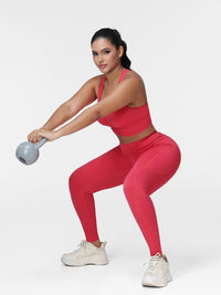 Women's running set in Cranberry Red - front view showing the twisted front bra and the pocket leggings.