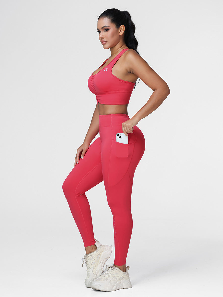 Women's running set in Cranberry Red - three quarter view showing the zipped side pocket with phone.