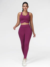 Women's running set in Deep Purple - front view showing the ruched sports bra and pocket leggings, two-piece set.
