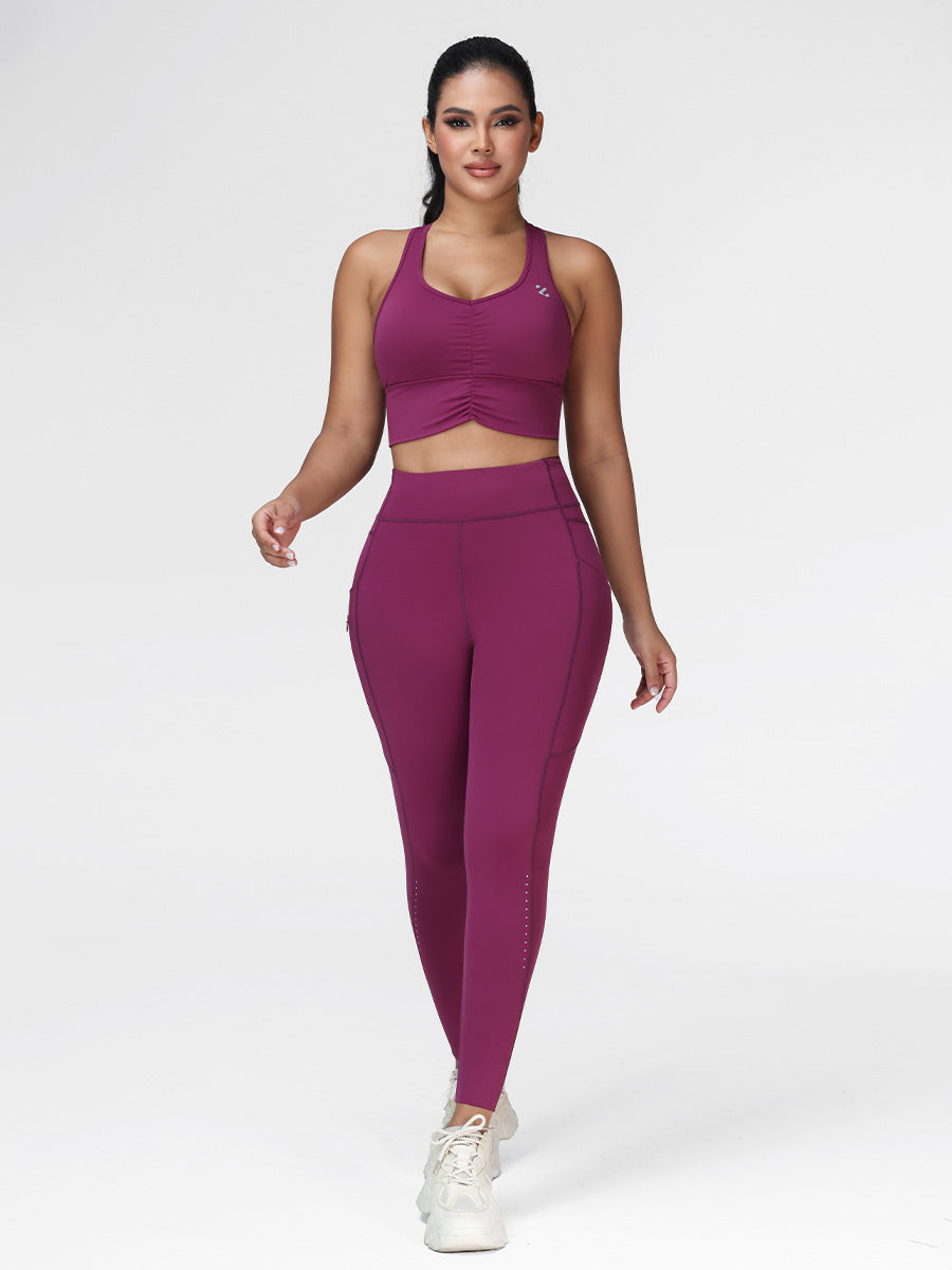 Women's running set in Deep Purple - front view showing the ruched sports bra and pocket leggings, two-piece set.