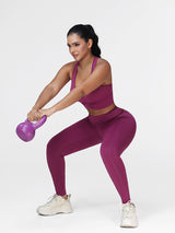 Women's running set in Deep Purple - front view showing the twisted front bra and the high waist leggings.