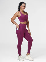 Women's running set in Deep Purple - three quarter view showing the ruched bra and the zipped pocket.